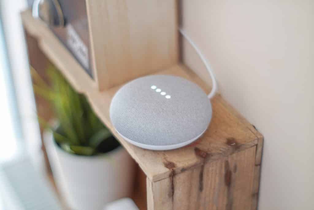 Google Home Mini Smart Speaker on brown board